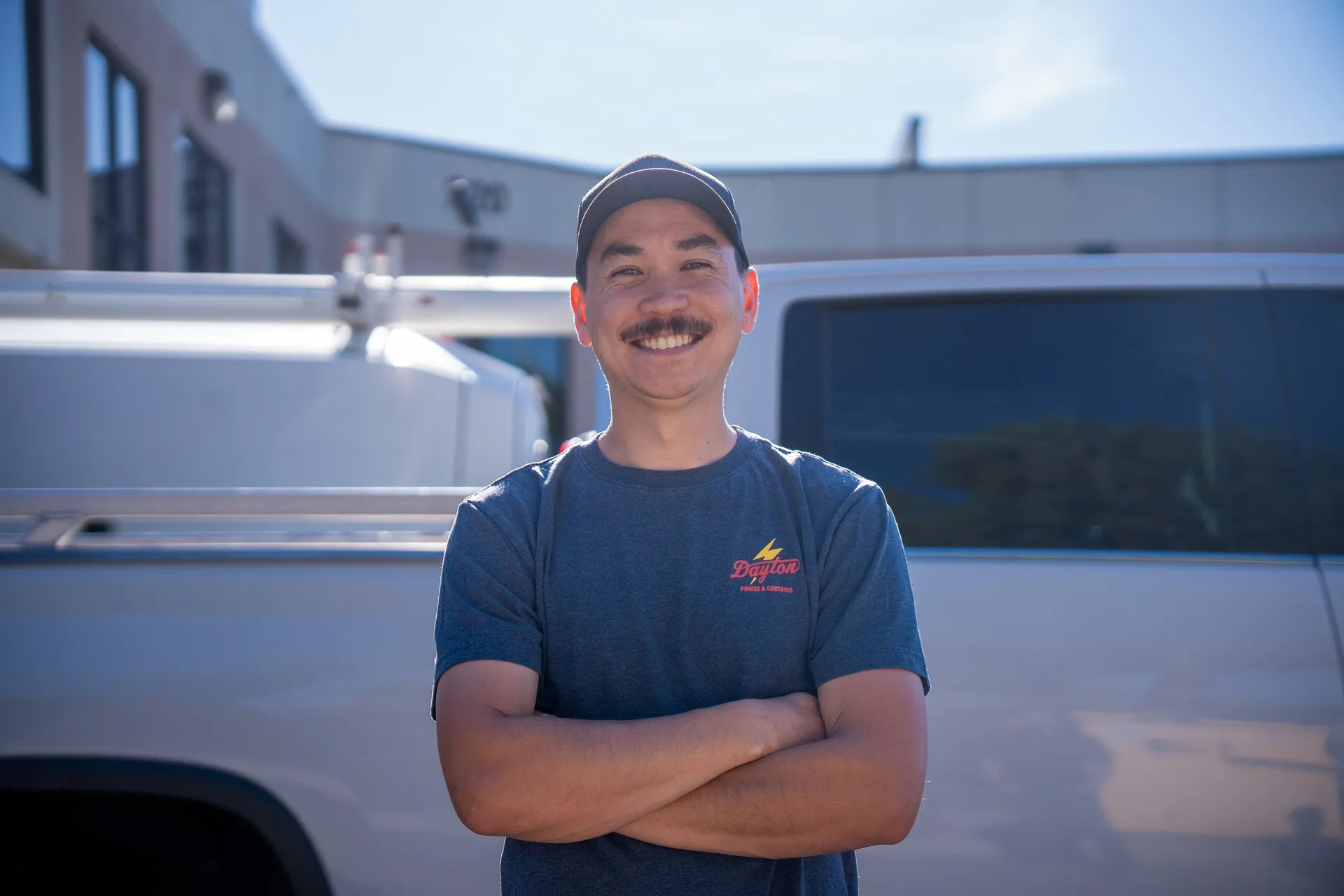 Rhys, co-founder of Dayton Power & Controls, standing in front of a company service truck